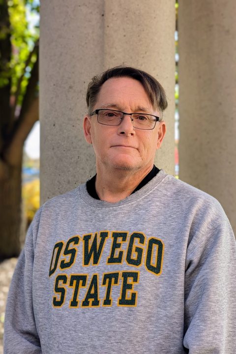 Assistant Director, Pat Devendorf, standing outside and smiling at the camera