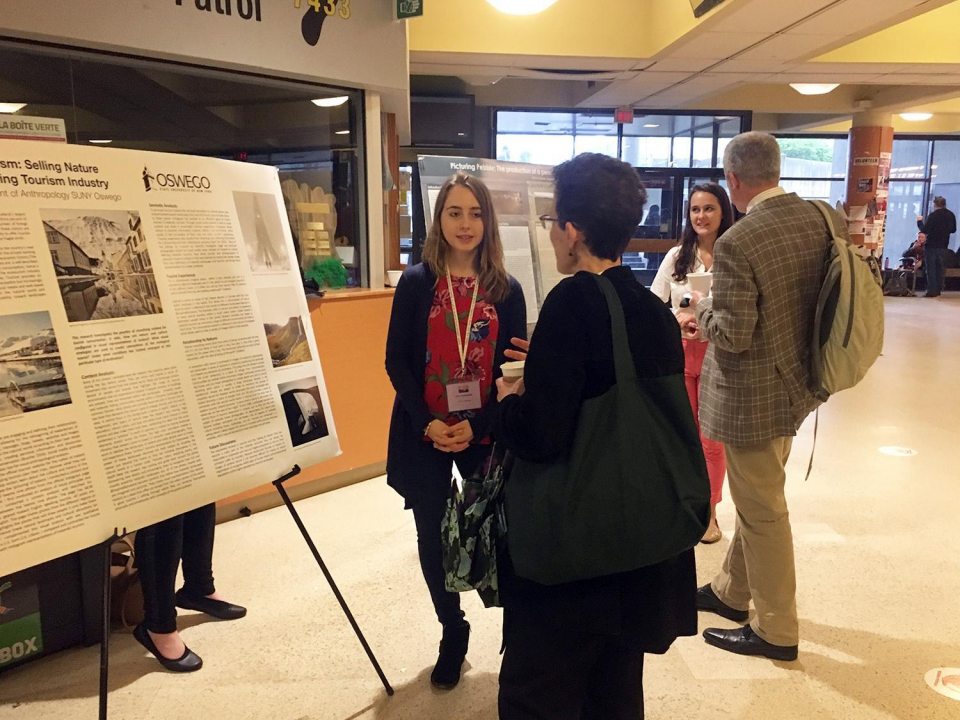 Two students presenting a research poster at a conference