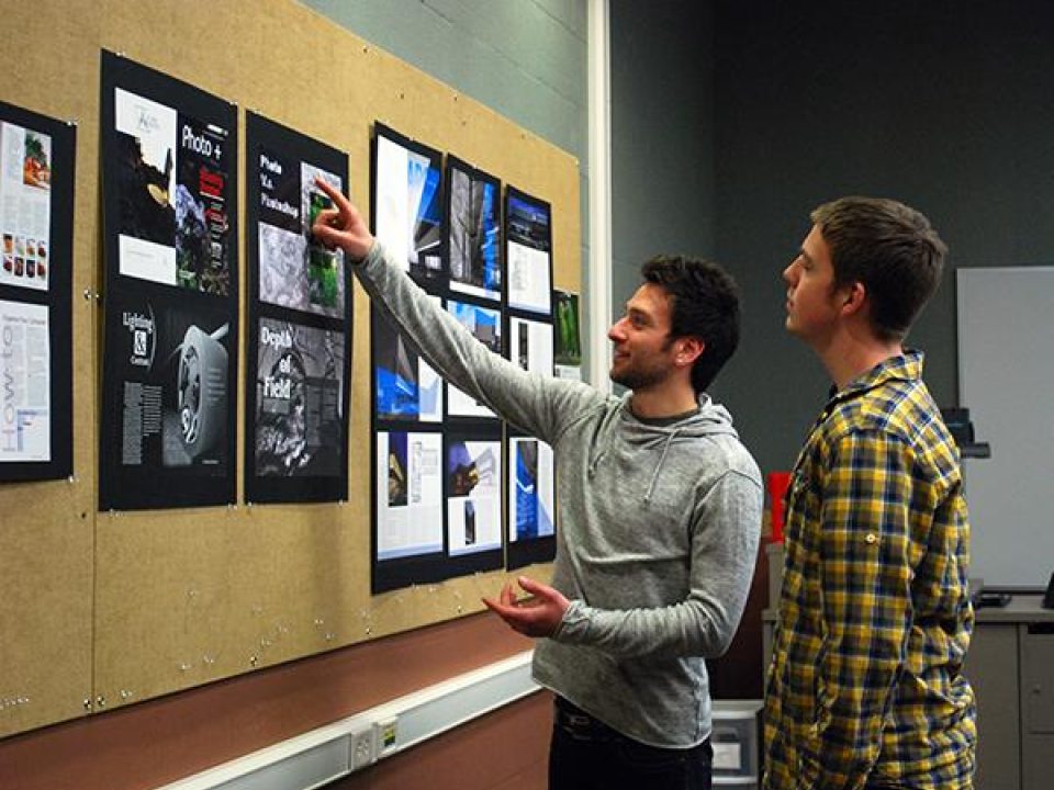Students looking at artwork hanging in a gallery