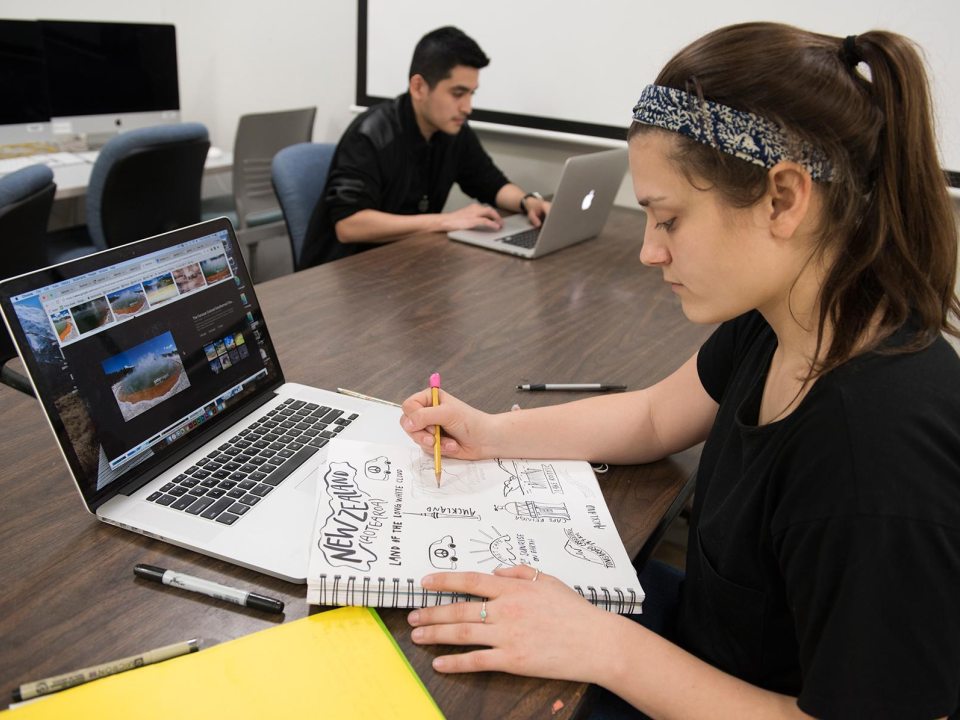 Two students working on laptops