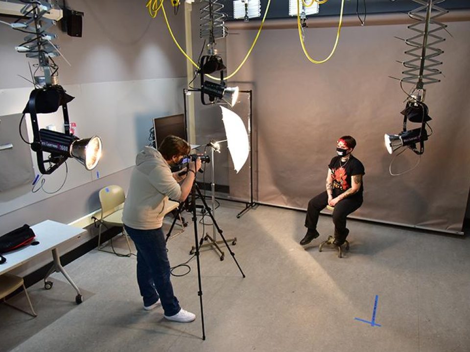 A student being photographed in the digital photography studio