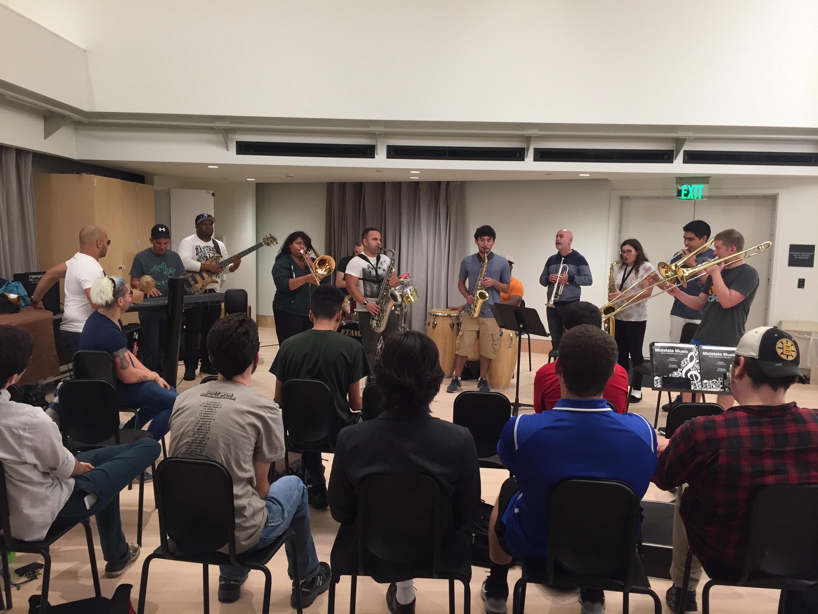 A group of musicians performing for a small audience
