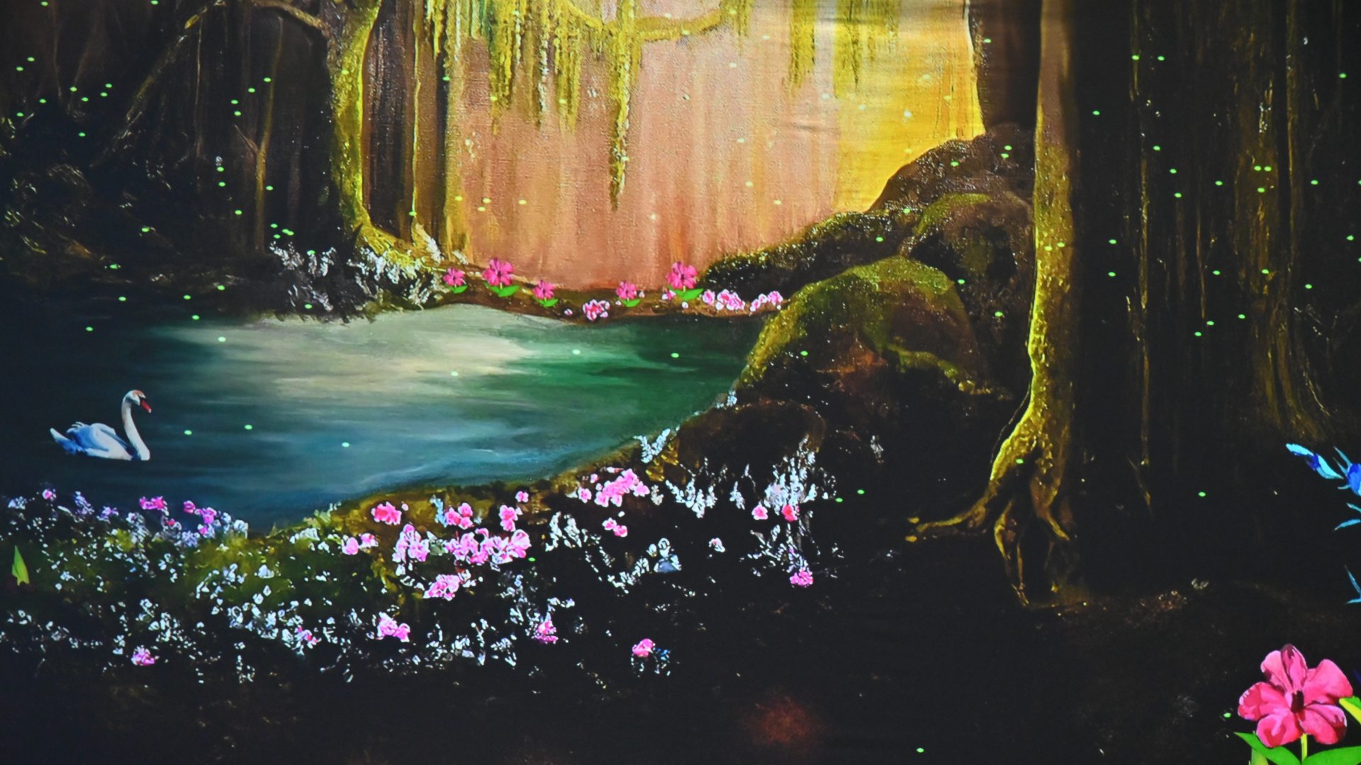 A student-created screen featured in the Immersive Elements Installation, featuring a serene woodland pool, trees, flowers, and a swan.