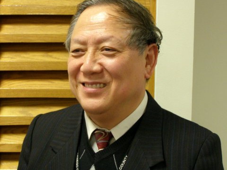 Jiancheng Huang smiling in a black sportscoat