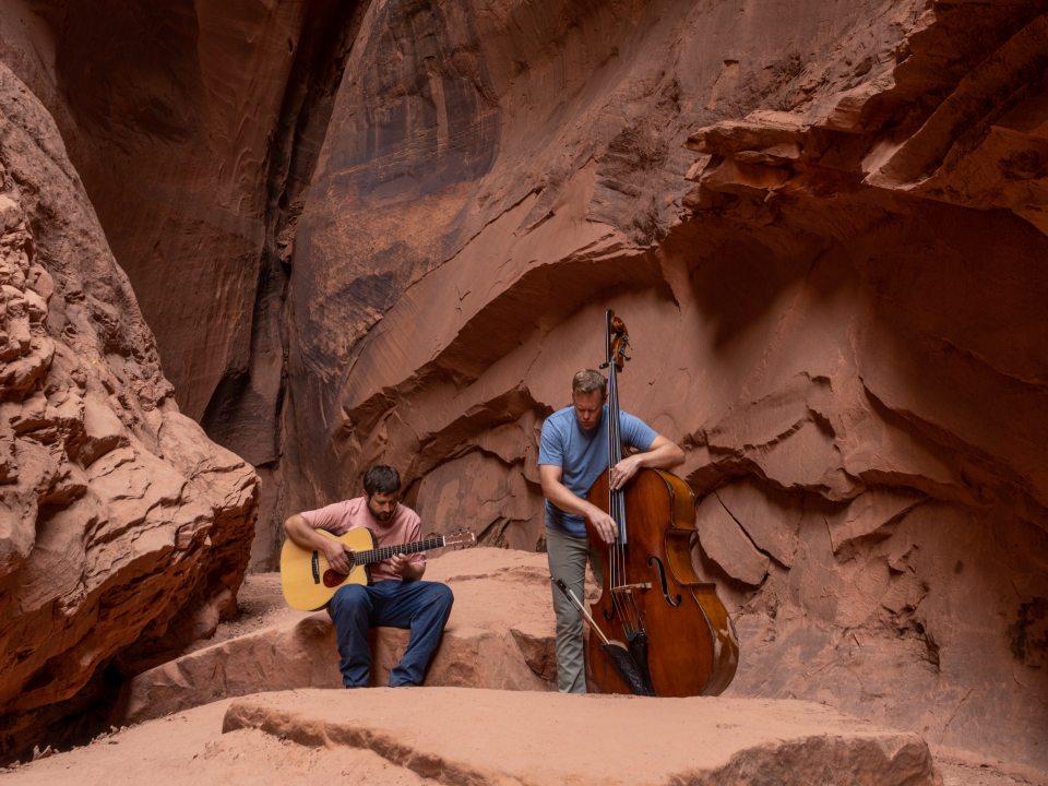 Duo Endless Field playing their instruments in Slot Canyon, Utah.
