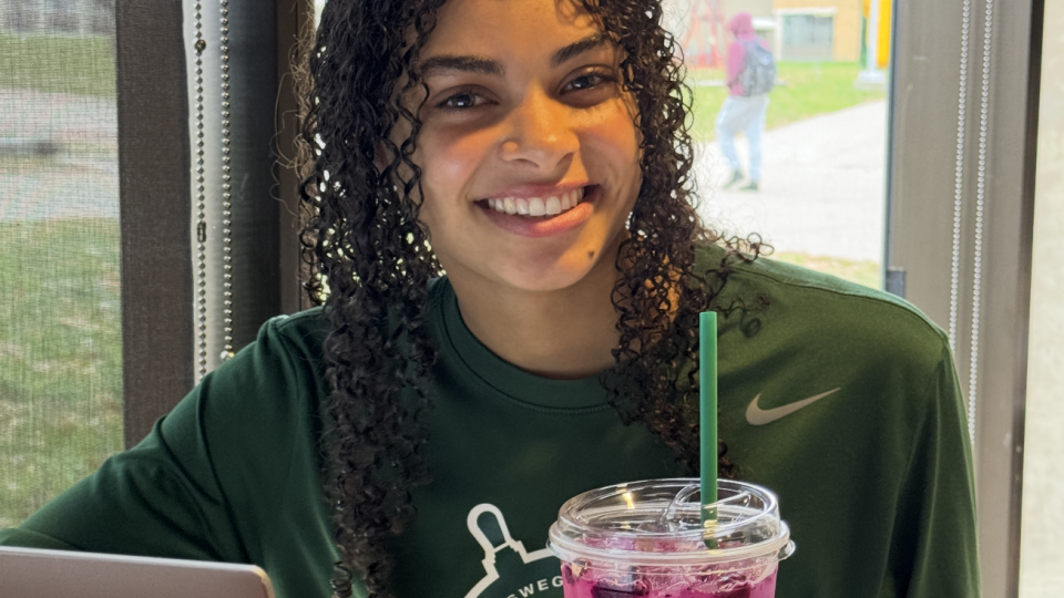 Student enjoying a drink from Lake Effect. 