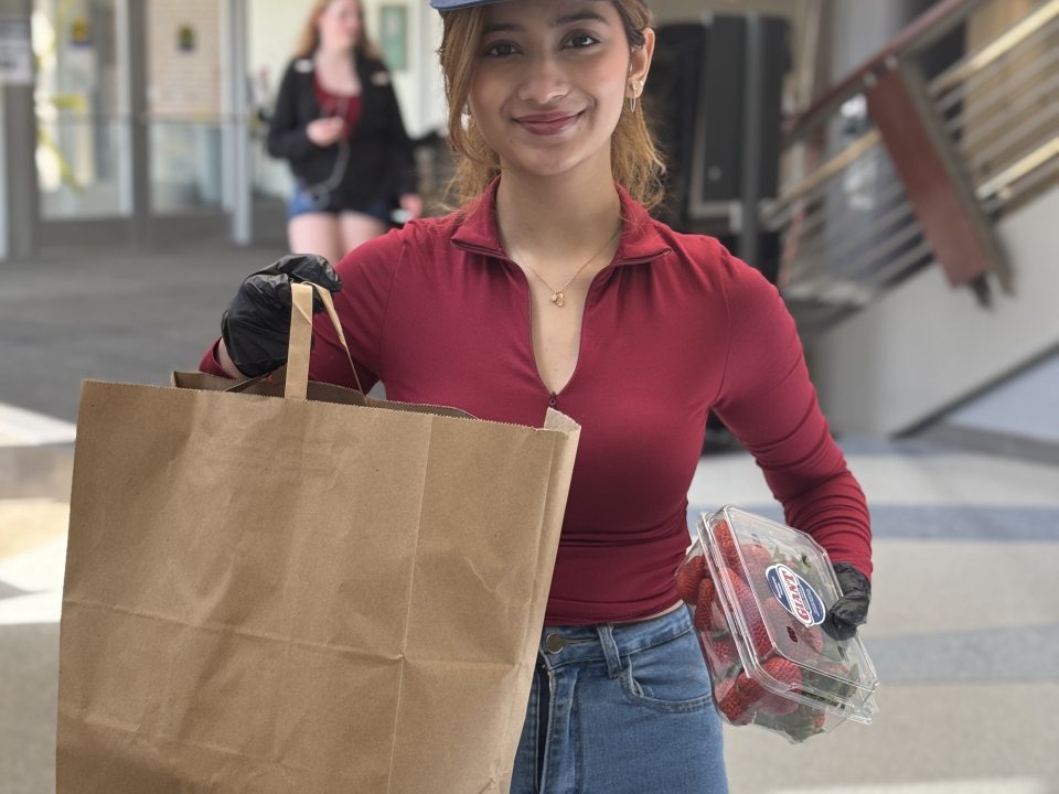 Student holding a paper bag. 