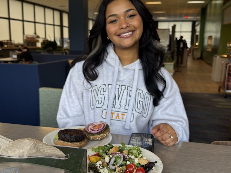 Student in Pathfinder with plates of food in front of them. 