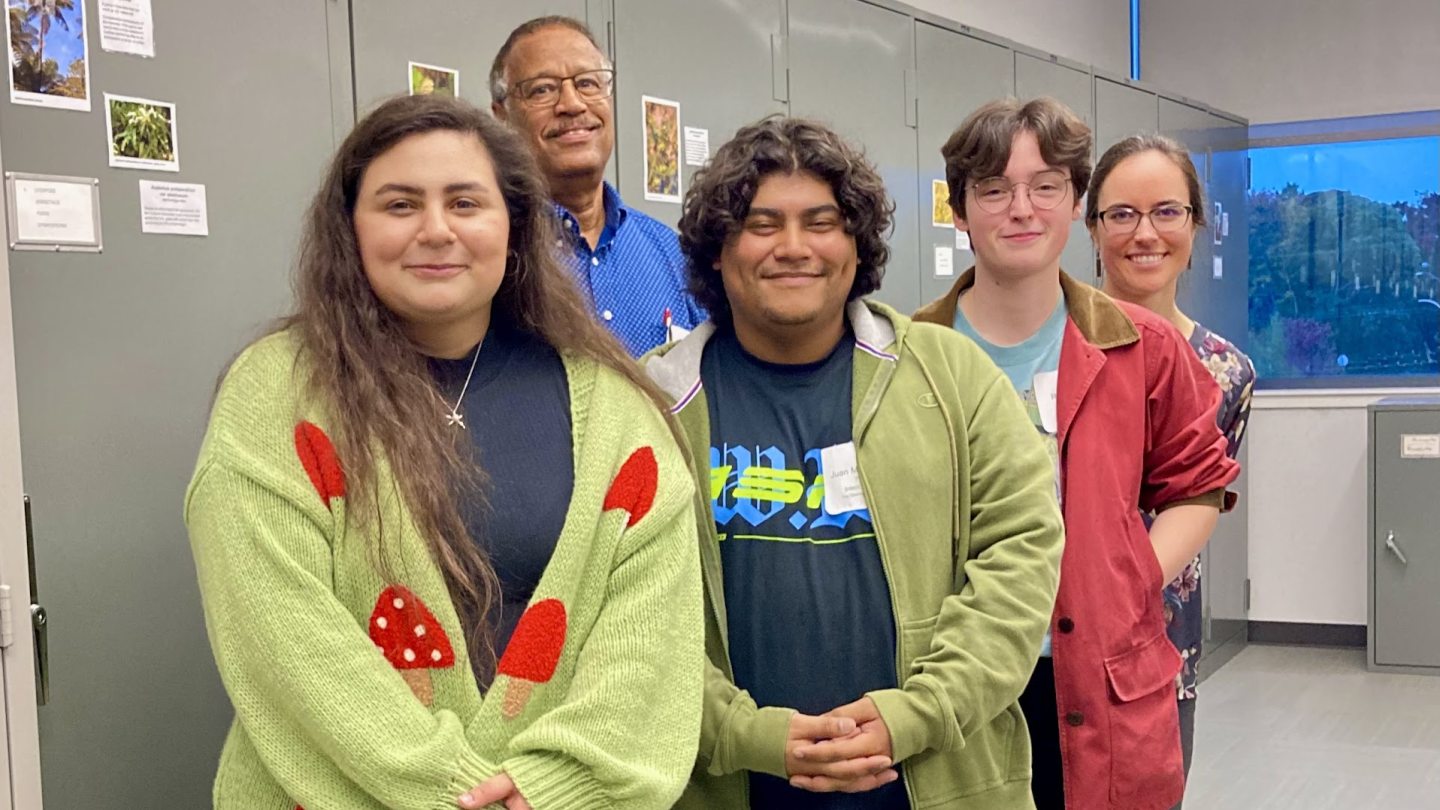 A group of people standing in the lab, smiling