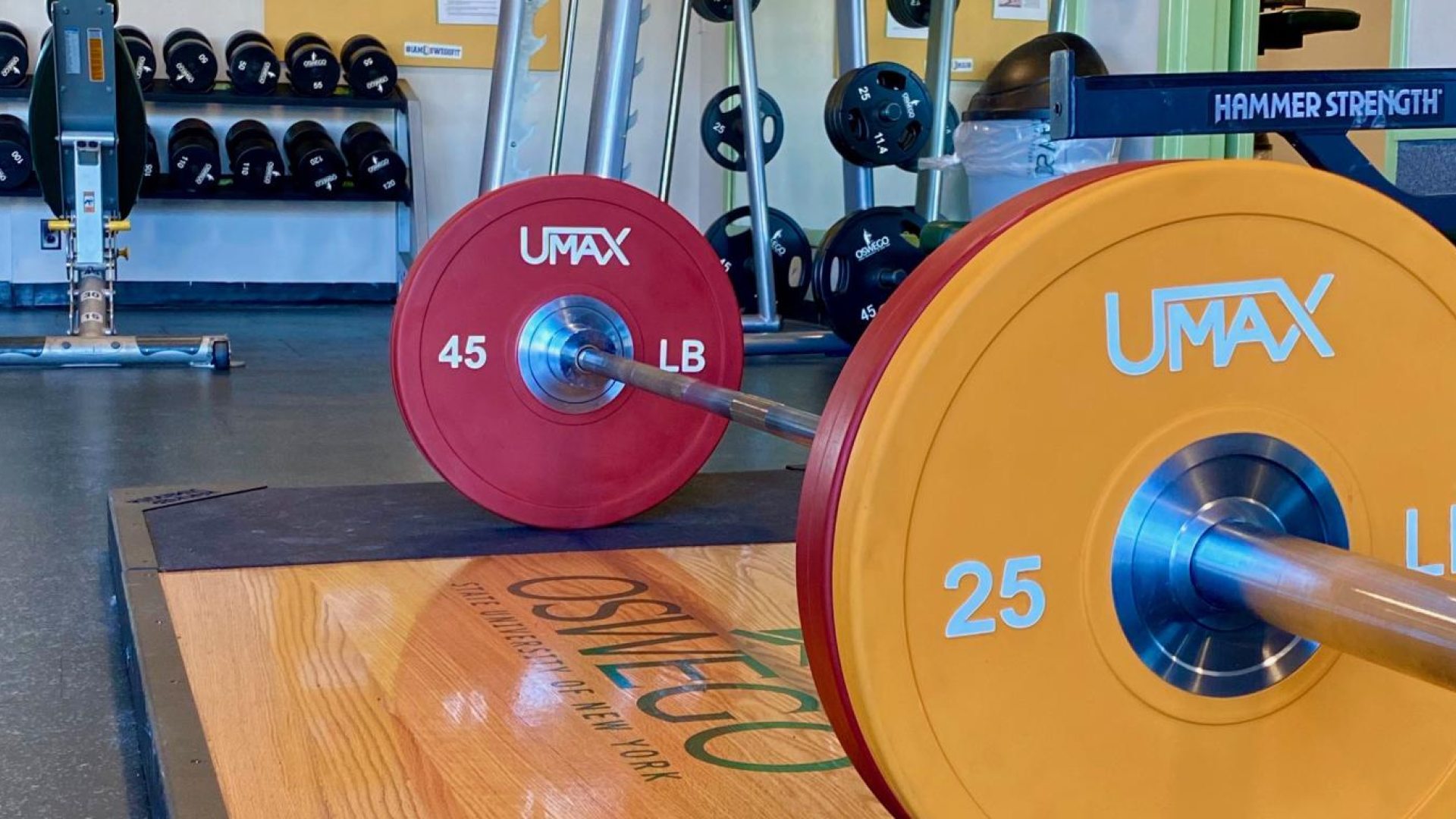 A barbell with red and yellow weights on each end