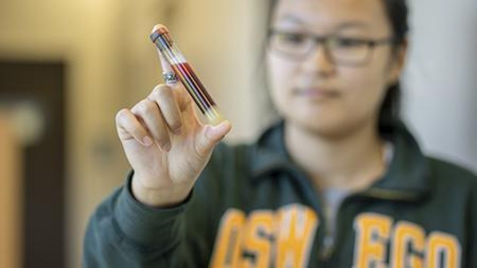 A student holding a vial of blood