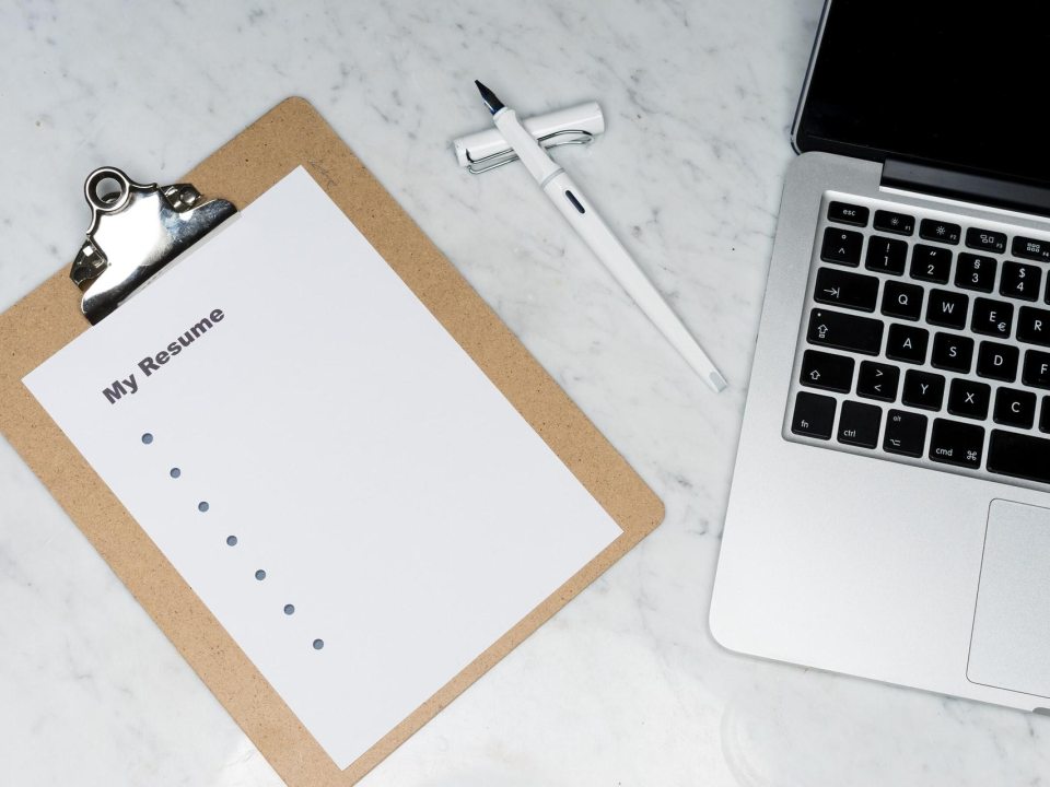 A laptop and a resume checklist