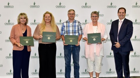 Oswego faculty members holding awards