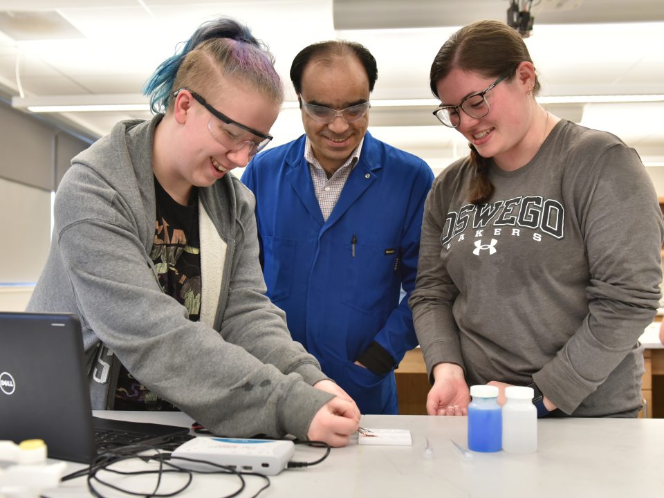 Three people looking at a specimen sample