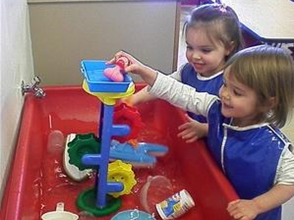 children playing at a water table
