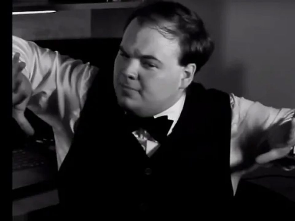 Black and white image of Alexander Griffin directing a film