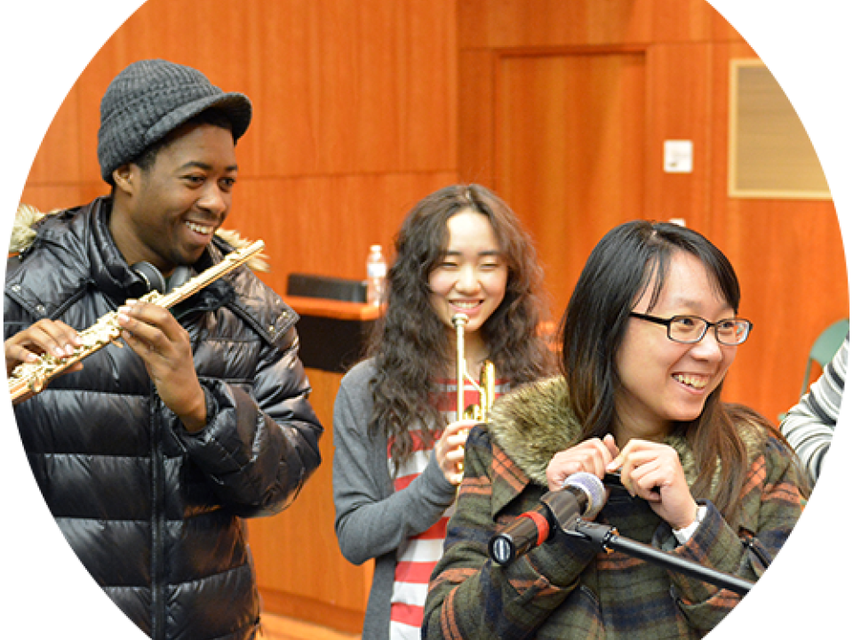 Music Club students smiling and playing instruments