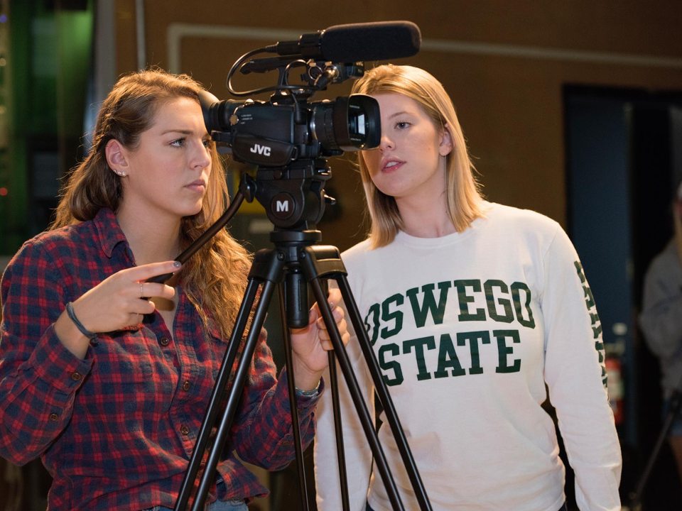 two students working with camera