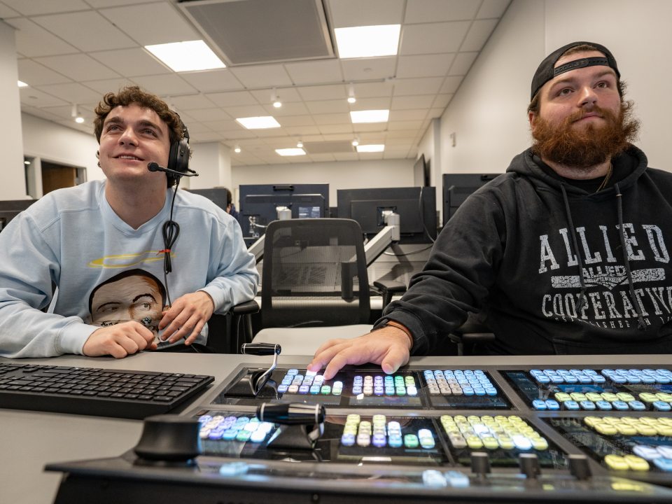 Students at the switcher in the production control room