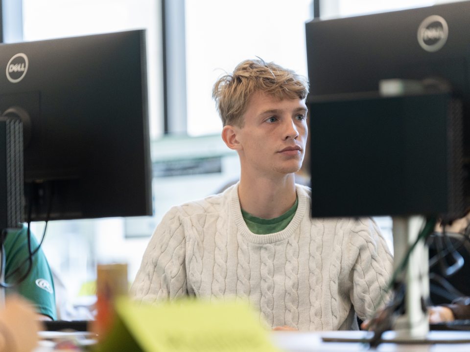 Student working in news and sports center 