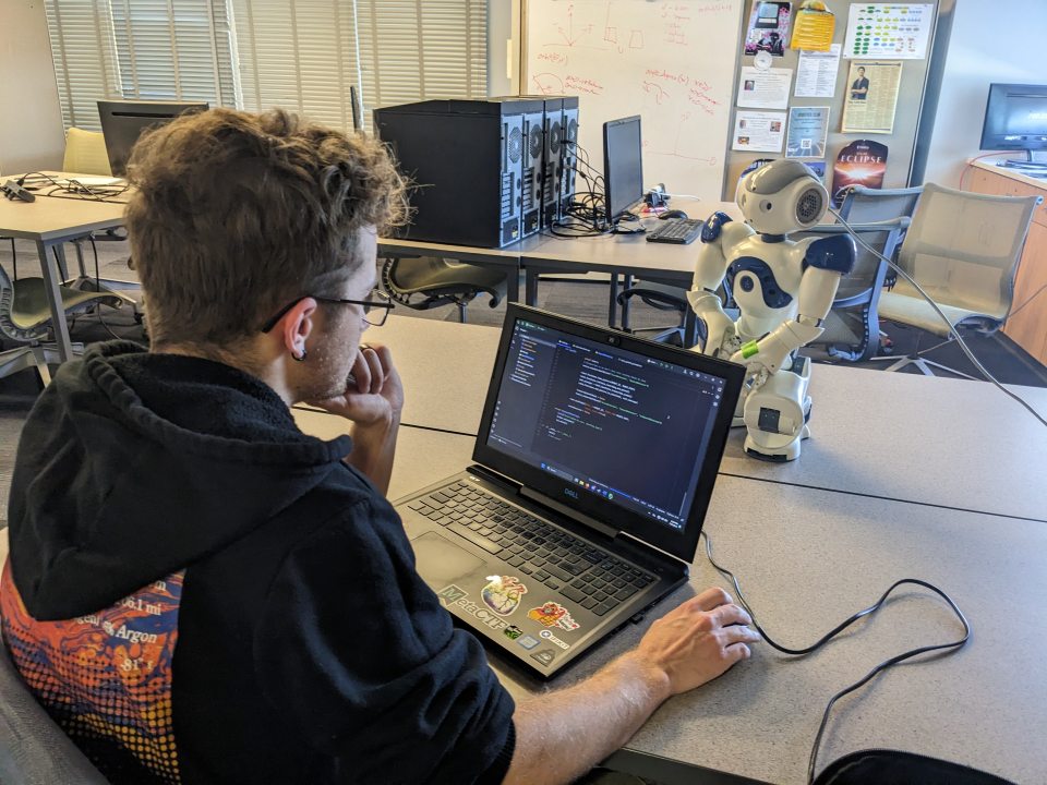Student Victor Lockwood programming robot