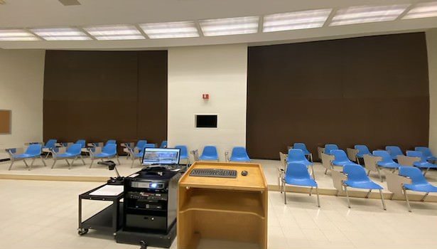 Photo of the podium equiptment in the room. Including Cart PC. Document Camera, projector and keyboard/mouse.