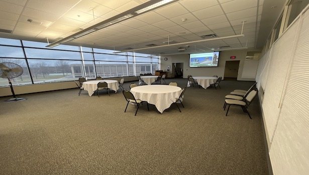 photo shows the back of the room from the right side including chairs and the podium.