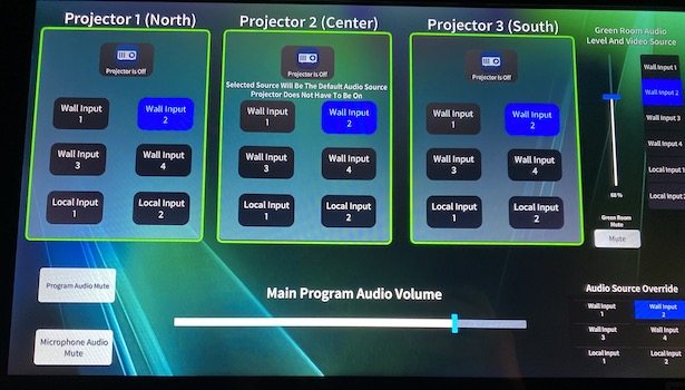 Photo showing the touch panel to change inputs in the closet of the room. Showing all 3 projectors and audio volume control.