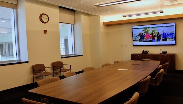 Entire room and what it looks like including the television in the front of the room.