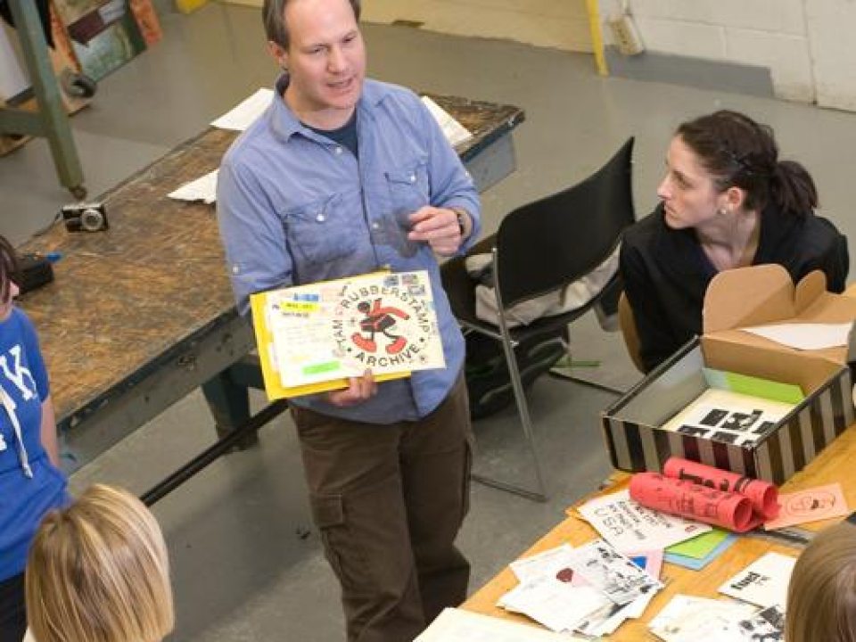 Professor mentoring students about art education