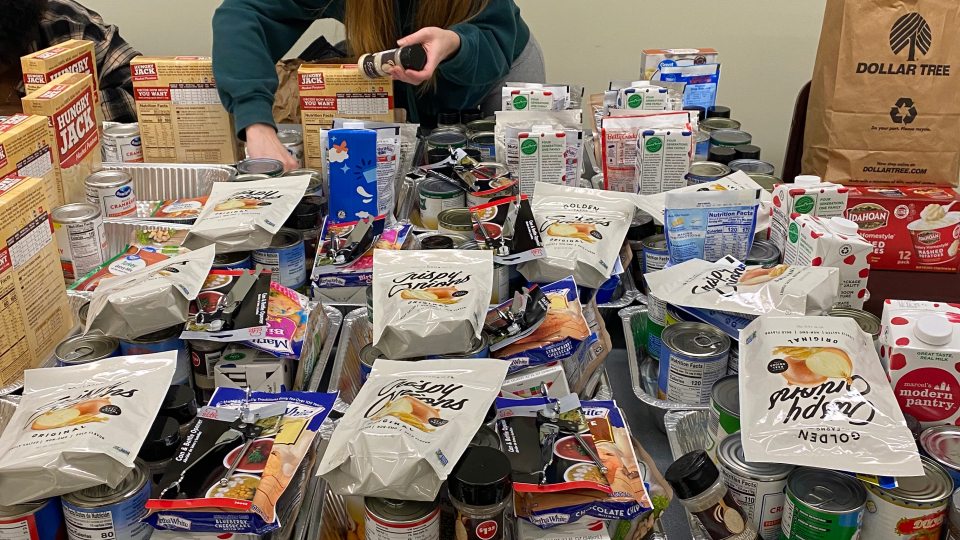 Student putting together Thanksgiving Baskets. 