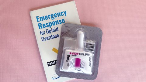 Narcan Nasal Spray laying on top of a Emergency Response for Opioid Overdose booklet