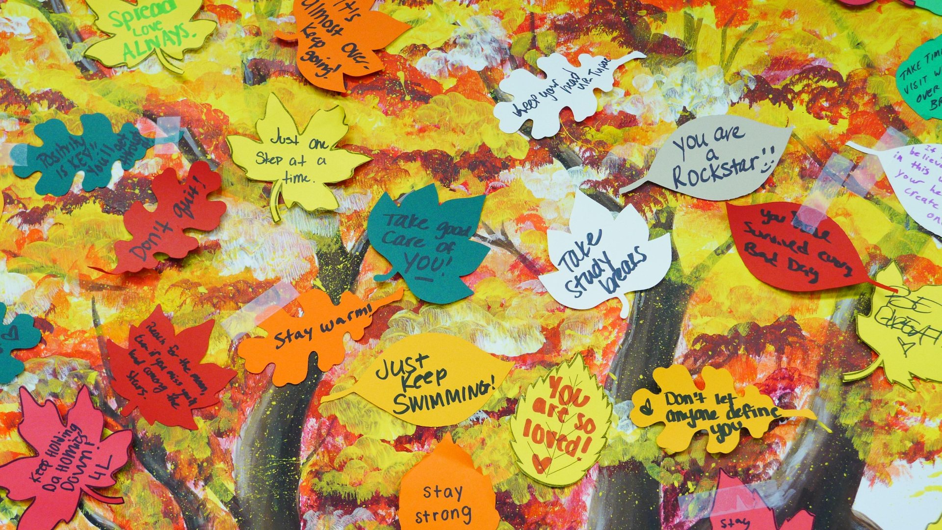 Painting of a tree with sticky note leafs. Positivity notes are written on them.