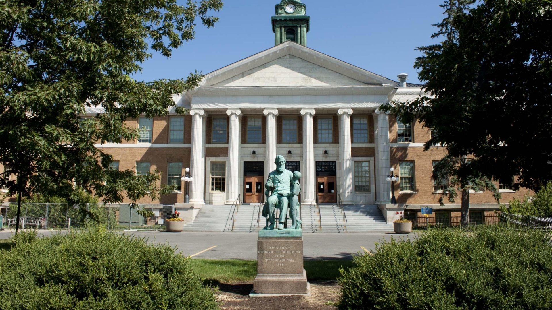 Front view of Sheldon Hall and statue