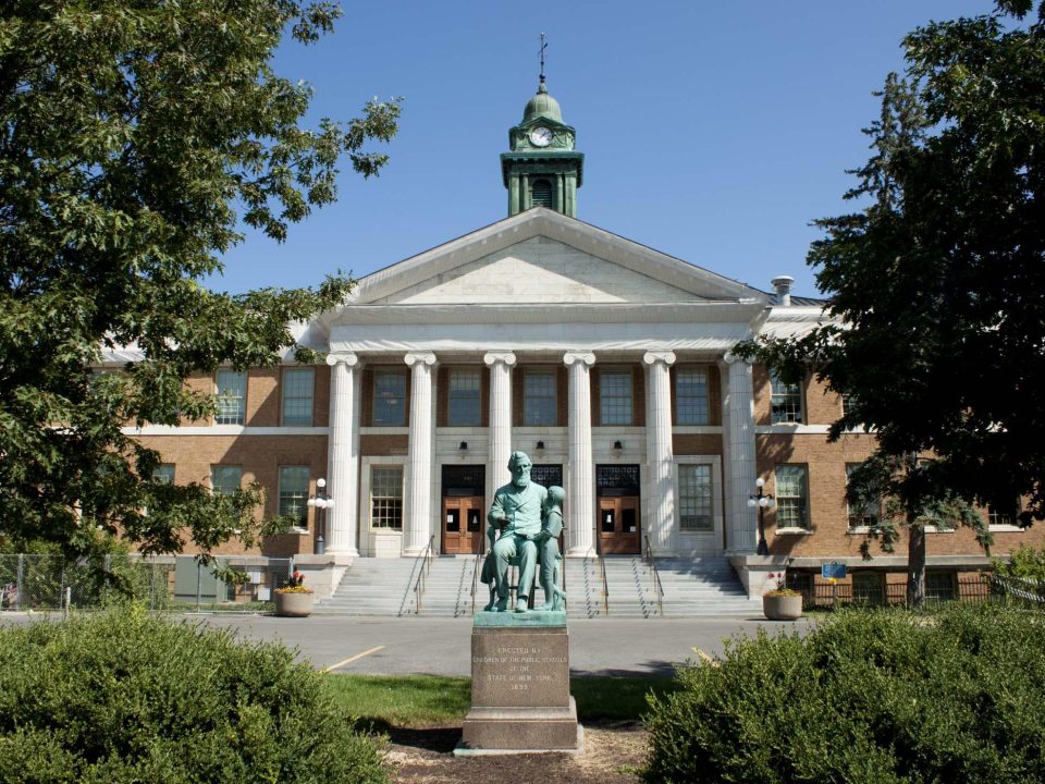 Front view of Sheldon Hall and statue