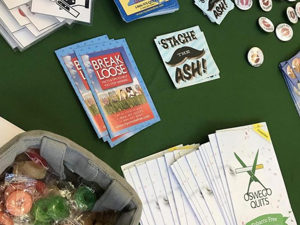 Table filled with pamphlets and stickers about kick butts day
