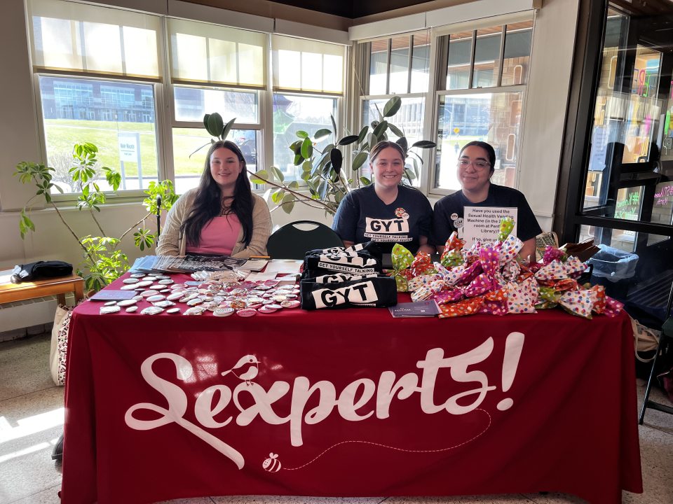 Three Sexperts tabling inside the waiting room of Dr. Mary Walker Health Center for the Get Yourself Tested event