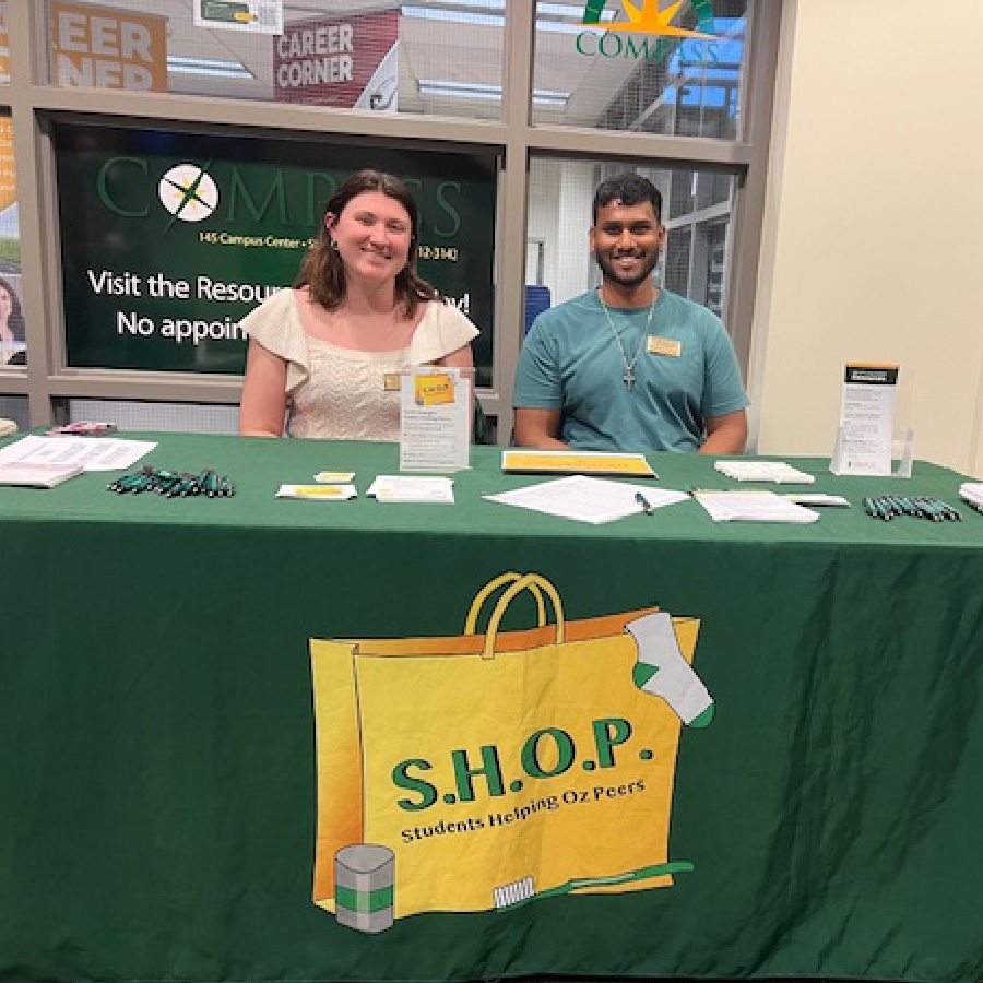 Smiling SHOP volunteers at a tabling event