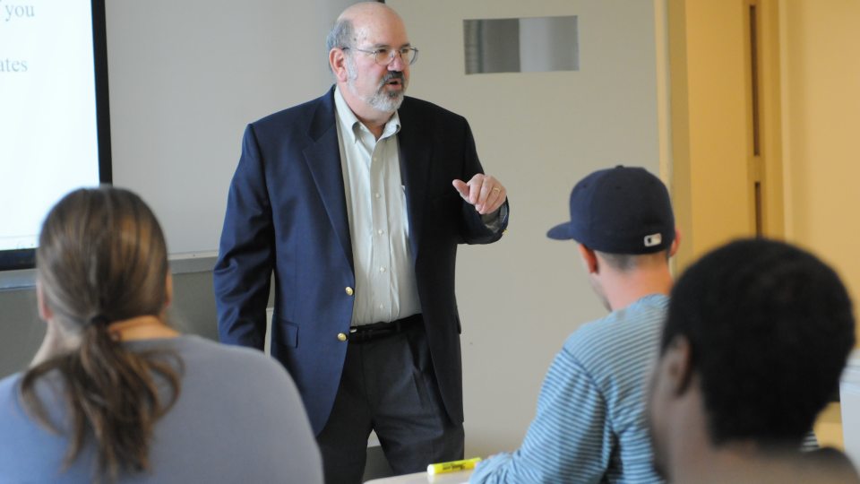 Economic Professor presenting to a class