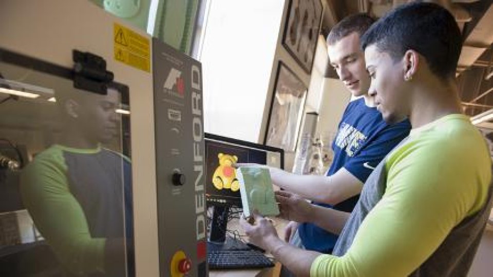Two students looking at a 3D printing