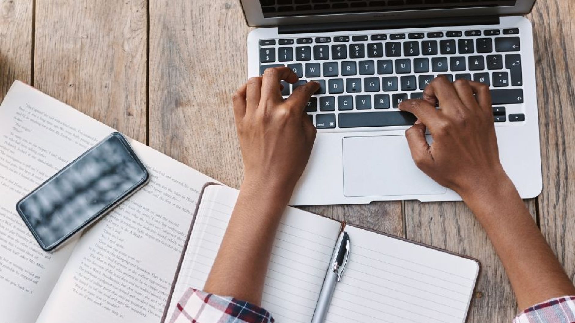 Picture of person typing on a  laptop