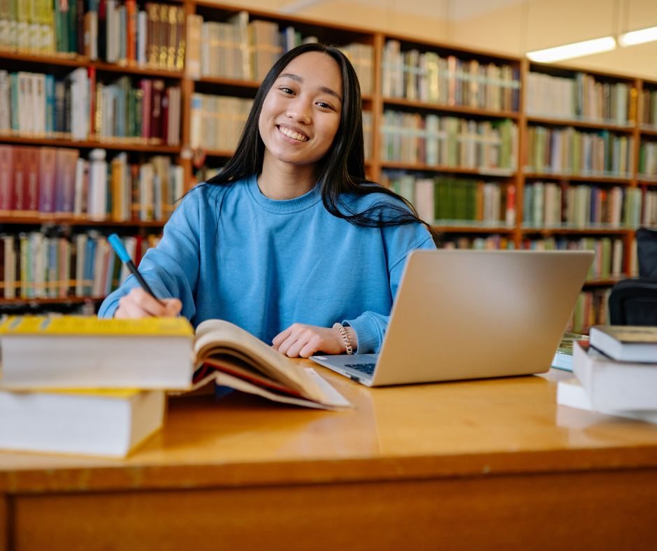 Student with books and laptop