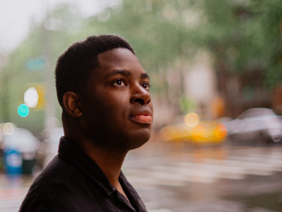 Man looking upwards in front of a street backdrop