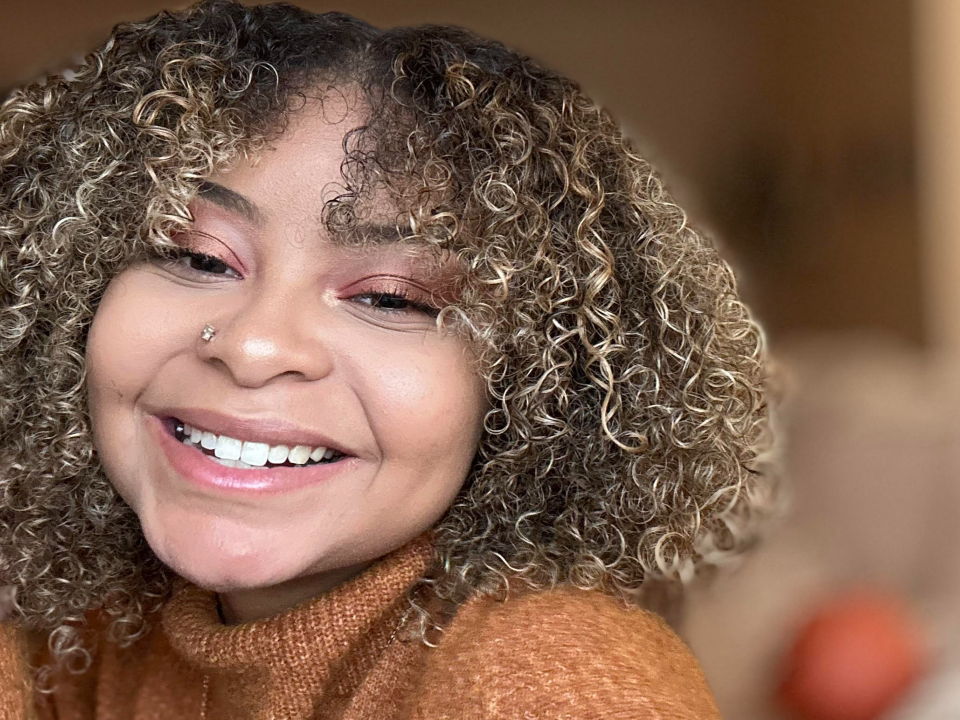 Smiling woman with curly brown hair