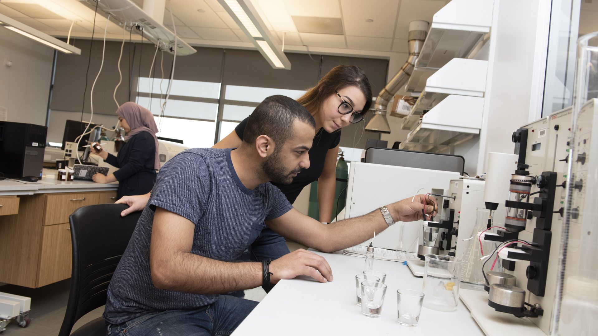 woman and man working together in a chemistry lab