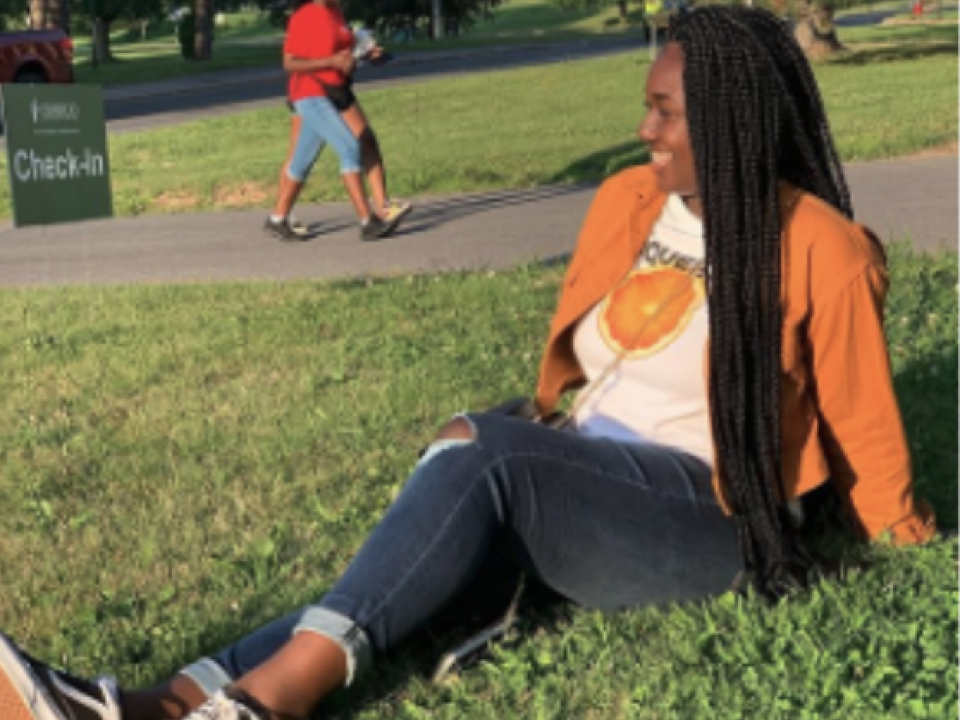 student sitting on the campus lawn