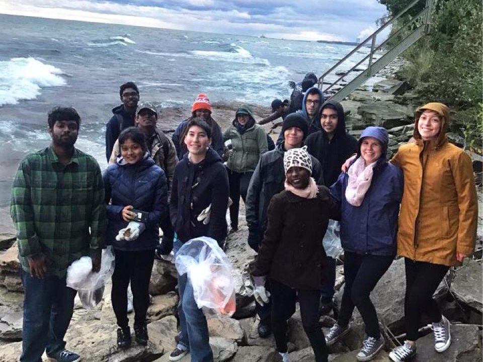 students volunteering by the lake
