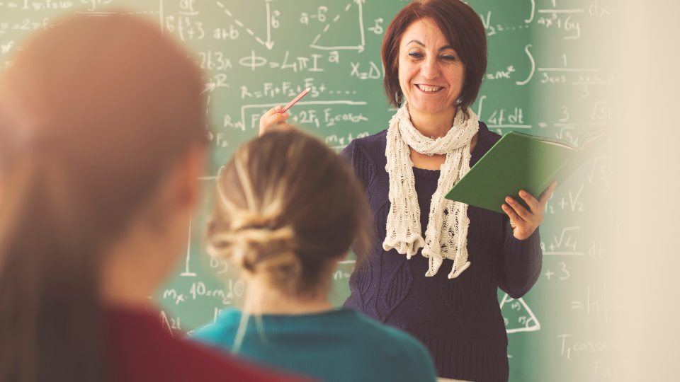 high school teacher in front of class