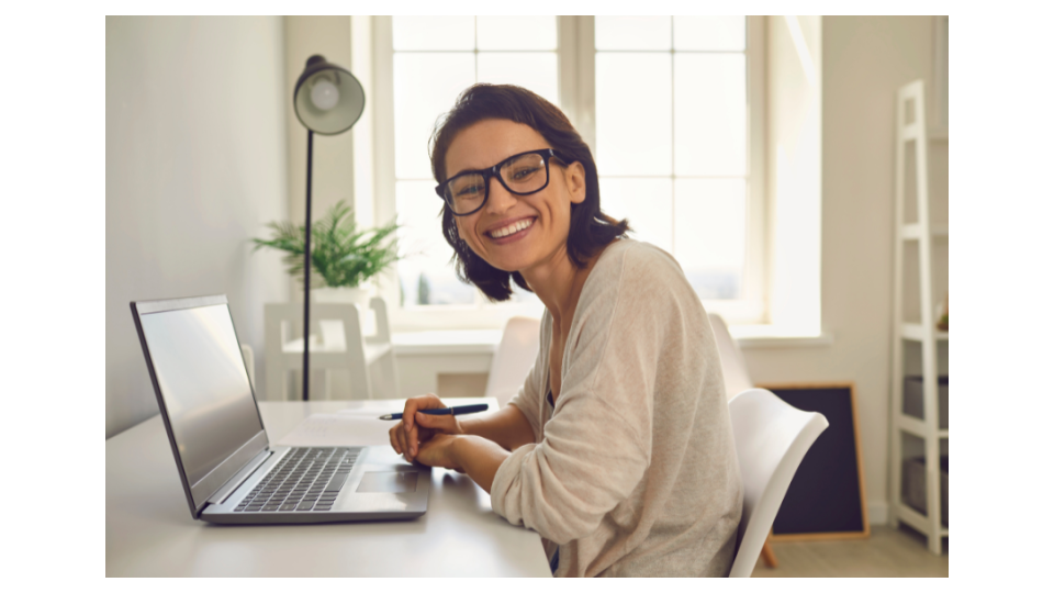 smiling woman working on computer at home