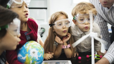 student with teacher doing  a science experiment